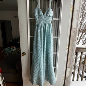 A never been worn before tags still attached size 3 long light blue green dress.